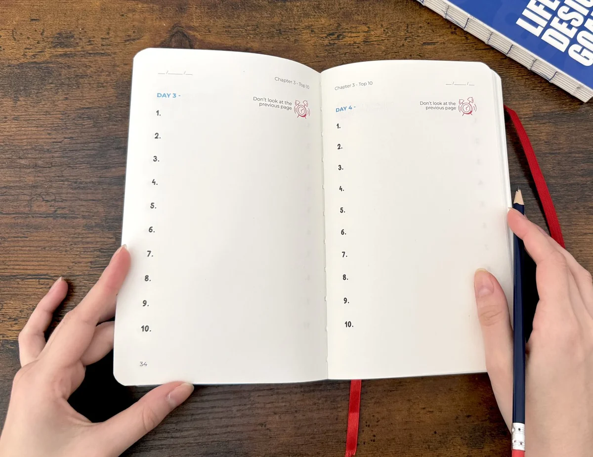 The Life Designer Goal planner — open with hands